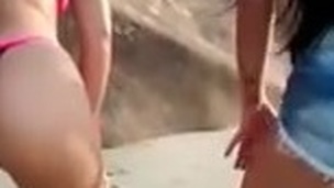 Summer surrounding Brazil - Two sluts wiggling the ass on the beach.