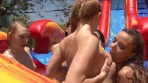 Lesbians outdoors pussylicking on waterslide